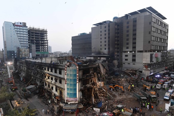 epa12668149 Rescue works continue at Gul Plaza after a fire in Karachi in Karachi, Pakistan, 21 January 2026. Karachi?s Gul Plaza fire death toll rose to 60 as bodies were recovered from shops in the  ...