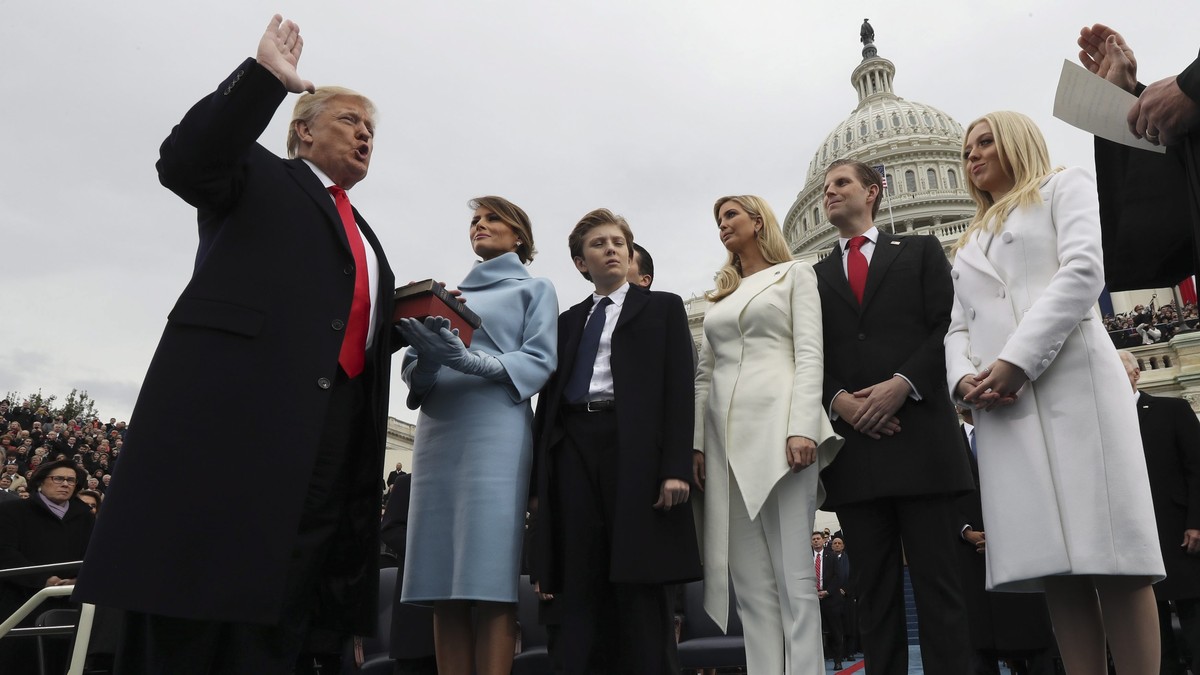 epa05735721 US President Donald J. Trump takes the oath of office as his wife Melania holds the bible and his children Barron, Ivanka, Eric and Tiffany watch as U.S. Supreme Court Chief Justice John R ...