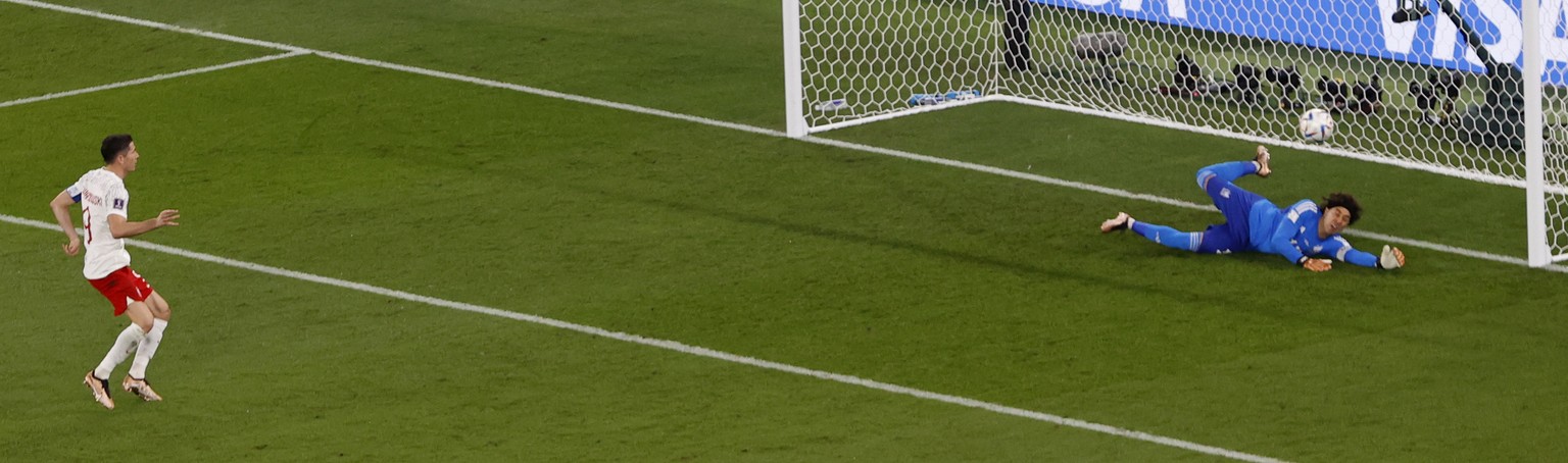 epa10321025 Goalkeeper Guillermo Ochoa (R) of Mexico saves a penalty of Robert Lewandowski of Poland during the FIFA World Cup 2022 group C soccer match between Mexico and Poland at Stadium 947 in Doh ...