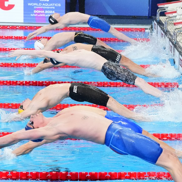 Athletes start in a men&#039;s 50 meters backstroke semifinal at the World Aquatics Championships in Doha, Qatar, Saturday, Feb. 17, 2024. (AP Photo/Hassan Ammar)