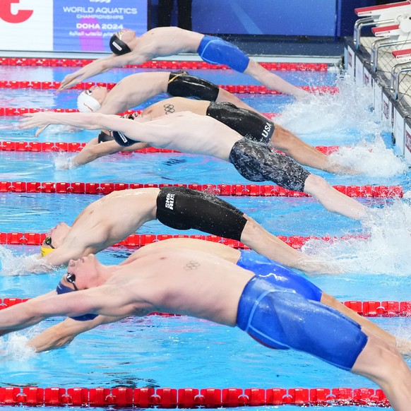 Athletes start in a men&#039;s 50 meters backstroke semifinal at the World Aquatics Championships in Doha, Qatar, Saturday, Feb. 17, 2024. (AP Photo/Hassan Ammar)