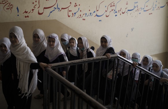 FILE - Girls walk upstairs as they enter a school before class in Kabul, Afghanistan on Sept. 12, 2021. In a surprise decision the hardline leadership of Afghanistan&#039;s new rulers has decided agai ...