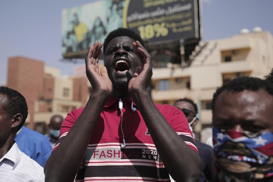 People chant slogans during a protest in Khartoum, Sudan, Saturday, Oct. 30, 2021. Pro-democracy groups called for mass protest marches across the country Saturday to press demands for re-instating a  ...