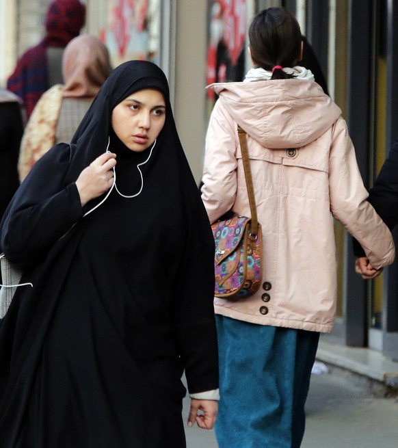 epa10398198 Iranian women walk in a street in Tehran, Iran, 10 January 2023. According to Isna news agency Attorney General of the country has ordered Iranian police to &quot;firmly punish&quot; women ...