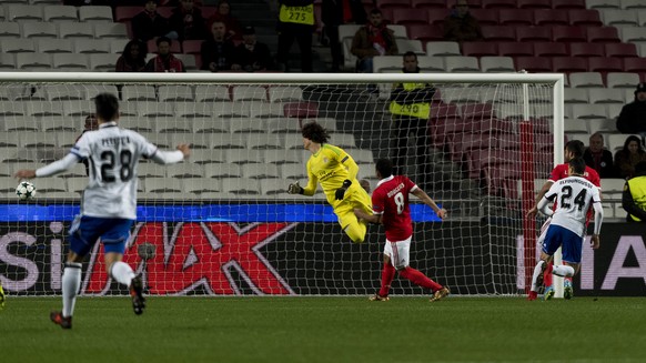 Basel&#039;s Mohamed Elyounoussi, right, scores against Benfica&#039;s goalkeeper Mile Svilar, center, during the UEFA Champions League Group stage Group A matchday 6 soccer match between Portugal&#03 ...