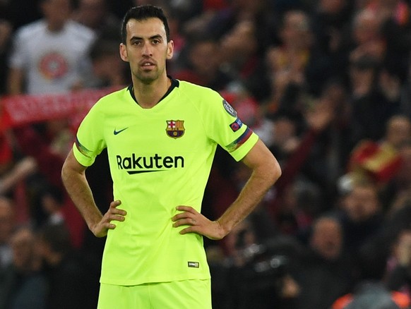 epa07554630 Gerard Pique (L) and Sergio Busquets of Barcelona react during the UEFA Champions League semi final second leg soccer match between Liverpool FC and FC Barcelona at Anfield, Liverpool, Bri ...