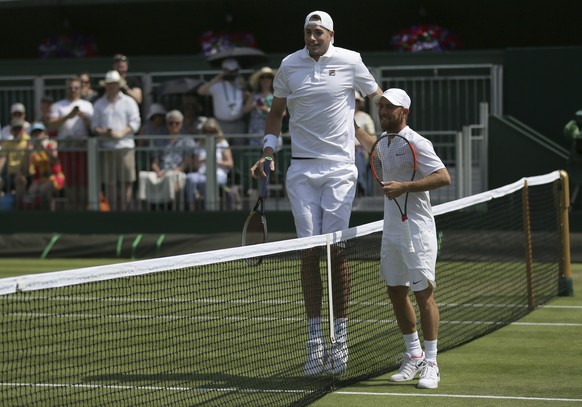 John Isner of the United States, left, and Israel&#039;s Dudi Sela pose for the media before their Men&#039;s Singles Match on day four at the Wimbledon Tennis Championships in London, Thursday, July  ...