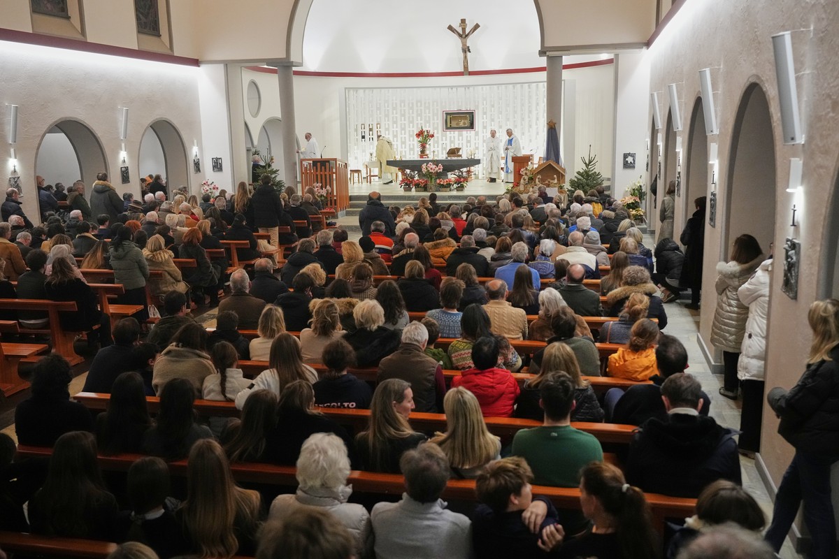People attend a New Year mass at the catholic church of Montana Station to remember the victims of the devastating fire at the Le Constellation bar, which left dead and injured during the New Year ...