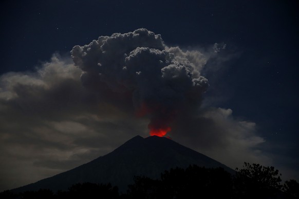 epa06848709 Mount Agung volcano spewing hot volcanic ash as seen from Kubu Village in Karangasem, Bali, Indonesia, 29 June 2018. The ash cloud out of Mount Agung was reported to stretch to a height of ...