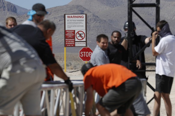 Workers erect a stage near a replica Area 51 gate sign at the Alien Research Center, Wednesday, Sept. 18, 2019, in Hiko, Nev. Visitors descending on the remote Nevada desert for â??Storm Area 51â? ar ...