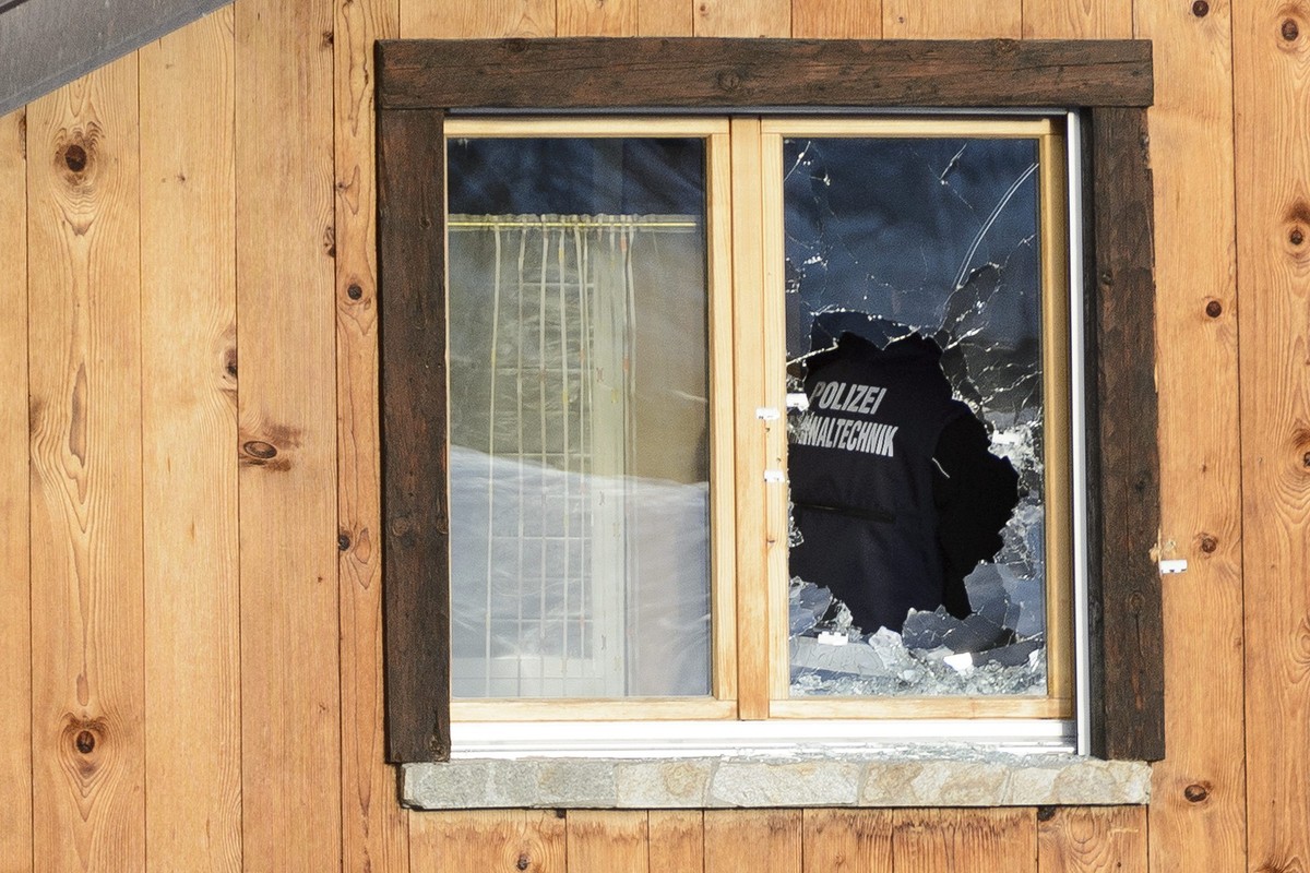 Police investigate traces of gun shots on the wall and on a broken windows on the neighbour house of the gunman in the scene after a shooting in the street of Daillon, Switzerland, Friday, January 4,  ...