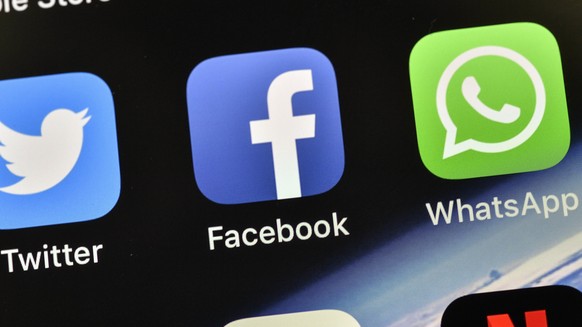 FILE - In this Thursday, Nov. 15, 2018 file photo, the icons of Facebook and WhatsApp are pictured on an iPhone, in Gelsenkirchen, Germany. Facebook&#039;s WhatsApp faces a complaint from European Uni ...