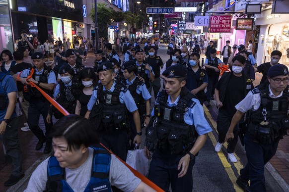 Police officers take away a member of the public in the Causeway Bay area on the eve of the 34th anniversary of China&#039;s Tiananmen Square massacre, in Hong Kong, Saturday, June 3, 2023. (AP Photo/ ...