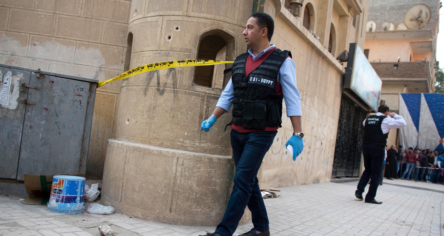 epaselect epa06408910 Security officials inspect the damage at Mar Mina church following an attempted attack on the church in the district of Helwan, southeastern Cairo, Egypt, 29 December 2017. At le ...