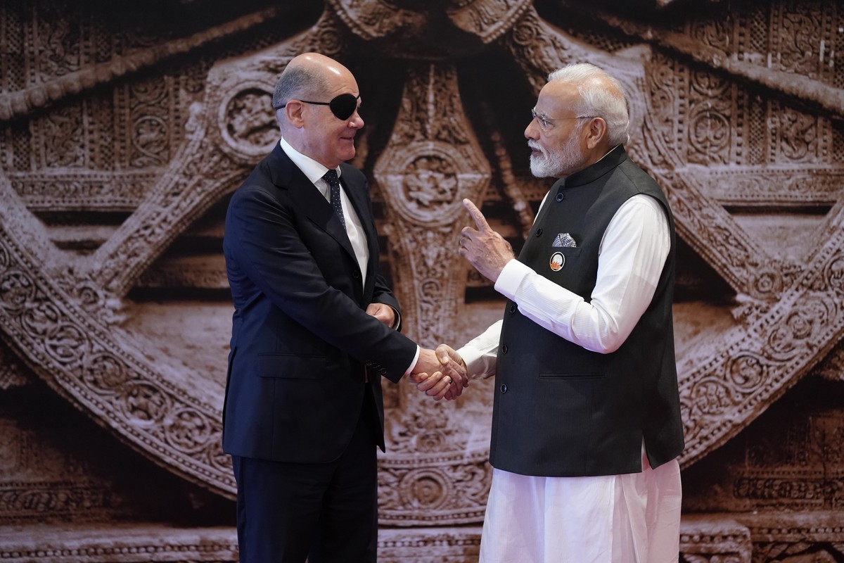 Indian Prime Minister Narendra Modi talks to Germany Chancellor Olaf Scholz upon his arrival at Bharat Mandapam convention center for the G20 Summit, in New Delhi, India, Saturday, Sept. 9, 2023. (AP  ...