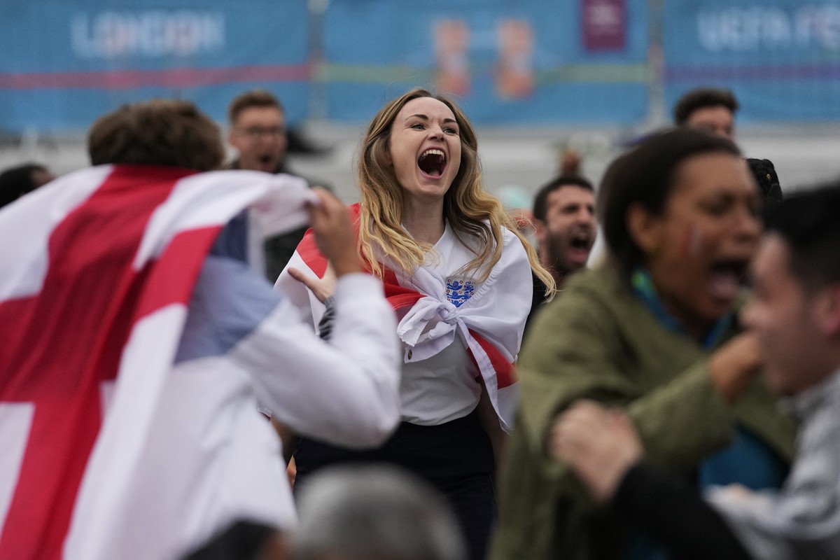 England fans celebrate their team's second goal as they watch the Euro 2020 round of 16 soccer championship match between England and Germany being played at London's Wembley stadium, at a f ...