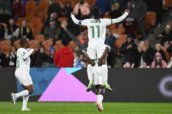 Zambia's top scorer Rachel Kundanange carries teammate Barbara Banda as Mary Willumby, left, runs as she celebrates her third goal during the Women's World Cup Group C football match between...