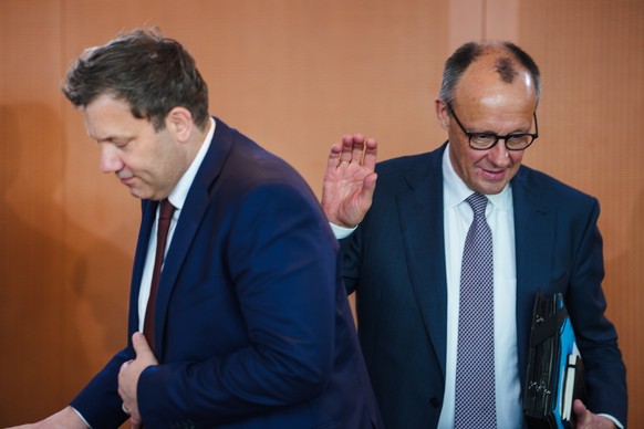 German Chancellor Friedrich Merz, right, and Vice Chancellor and Finance Minister Lars Klingbeil arrive at the cabinet meeting at the chancellery in Berlin, Germany, Wednesday, March 11, 2026. (AP Pho ...