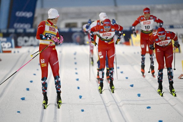 Norway's Johannes Hoesflot Klaebo, left, looks back as he competes during a heat of the men's cross-country skiing classic style sprint finals, at the Cross-Country Skiing World Cup Ruka Nordic Openin ...