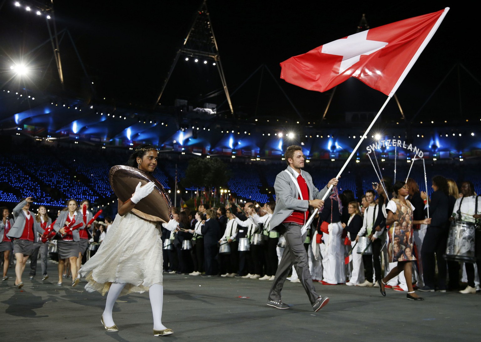 Switzerland&#039;s Stanislas Wawrinka carries the flag during the Opening Ceremony at the 2012 Summer Olympics, Friday, July 27, 2012, in London. (AP Photo/Matt Dunham)