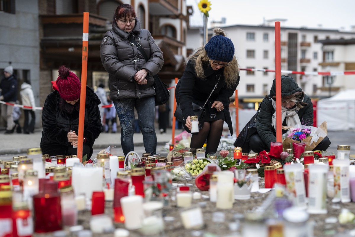 KEYPIX - People pay their respects to the victims with candles near the area where a fire broke out at the 'Le Constellation' bar and lounge during New Year's celebration, in Crans-Mont ...