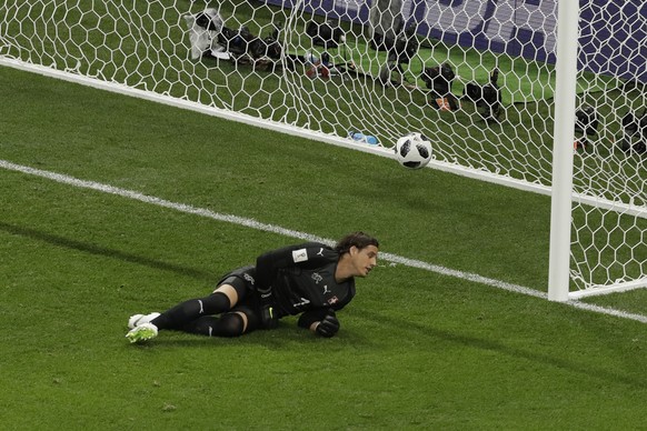 Brazil&#039;s Philippe Coutinho scores the opening goal of his team as Switzerland goalkeeper Yann Sommer lies on the ground during the group E match between Brazil and Switzerland at the 2018 soccer  ...