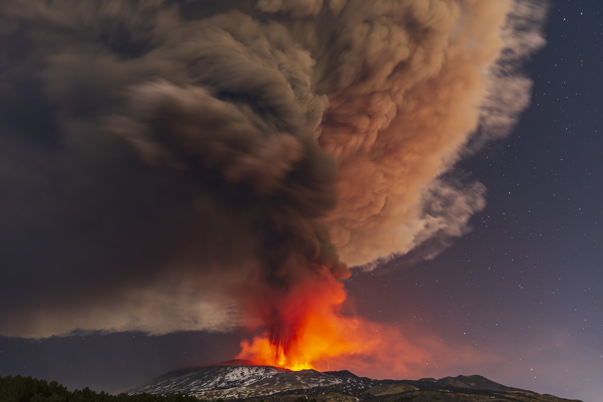 Smoke billows from the Mt. Etna volcano, as seen from Nicolosi, Sicily, southern Italy, Thursday, Feb. 10, 2022. (AP Photo/Salvatore Allegra)