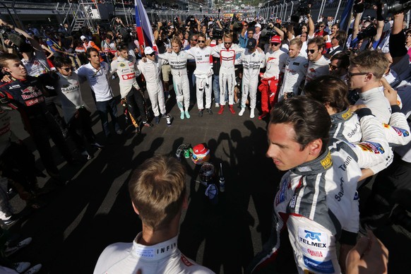 Formula 1 pilots stand in respect for French Formula One driver Jules Bianchi of Marussia F1 Team at the Sochi ?utodrom circuit in Sochi on October 12, 2014. Jules Bianchi was the focus of all thought ...