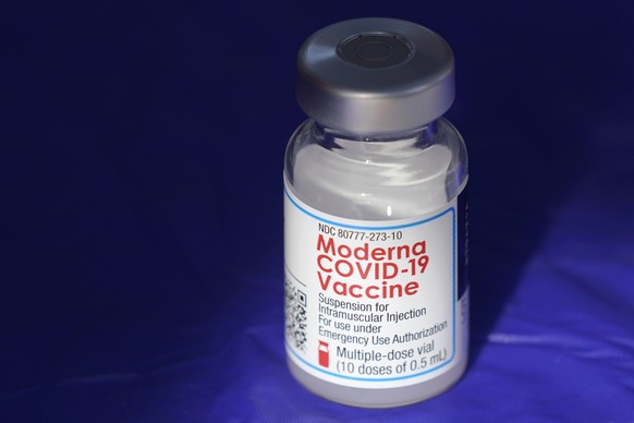 FILE - In this March 4, 2021 file photo, a vial of the Moderna COVID-19 vaccine rests on a table at a drive-up mass vaccination site in Puyallup, Wash., south of Seattle. Moderna is scaling back expec ...