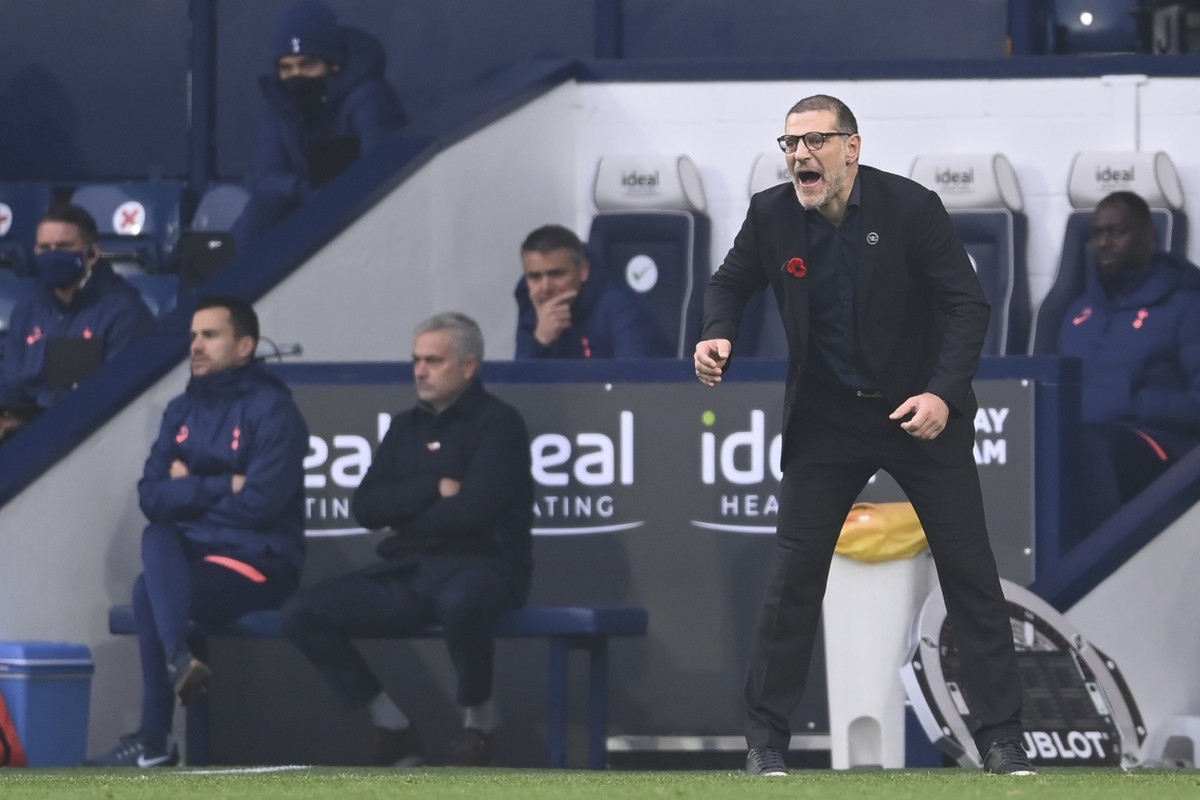 West Bromwich Albion's manager Slaven Bilic, right, shouts out from the touchline as Tottenham's manager Jose Mourinho sits on the bunch during the English Premier League soccer match betwee ...