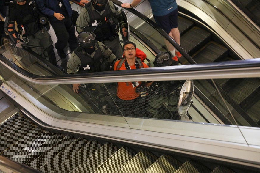 epa07969300 Police arrest a journalist during a rally against police brutality in Hong Kong, China, 03 November 2019. Hong Kong has entered a 22nd week of ongoing mass protests, originally triggered b ...