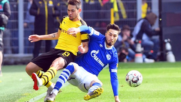 epa07532285 Dortmund&#039;s Raphael Guerreiro (L) in action against Schalke&#039;s Suat Serdar (R) during the German Bundesliga soccer match between Borussia Dortmund and FC Schalke 04 in Dortmund, Ge ...