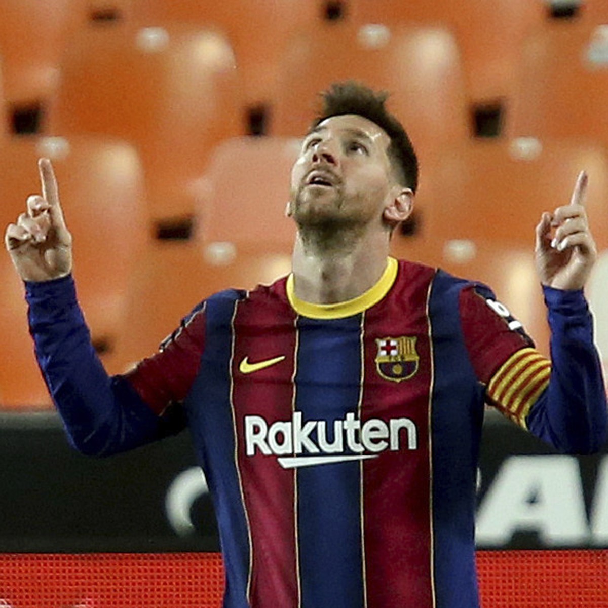 Barcelona's Lionel Messi celebrates scoring his side's 3rd goal during the Spanish La Liga soccer match between Valencia and Barcelona at the Mestalla stadium in Valencia, Spain, Sunday, May ...
