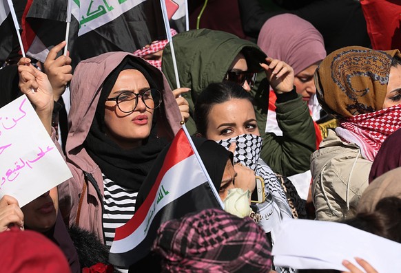 Women take part in a protest in Tahrir Square, Baghdad, Iraq, Thursday, Feb. 13, 2020. Hundreds of women took to the streets of central Baghdad and southern Iraq on Thursday in defiance of a radical c ...