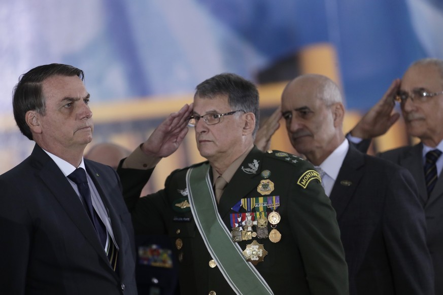 BrazilÄôs Army Chief General Edson Leal Pujol, second left, and retired military general officers, salute Brazil&#039;s President Jair Bolsonaro, left, during a ceremony with the countryÄôs new gene ...