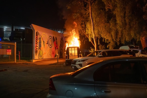 epa12925499 A police vehicle burns as community members clash with authorities outside Alice Springs Hospital in Alice Springs, Australia, 30 April 2026 (issued 01 May 2026). The riot erupted followin ...