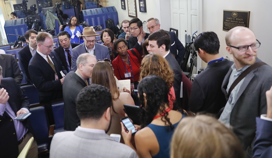 Reporters line up in hopes of attending a briefing in Press Secretary Sean Spicer&#039;s office at the White House in Washington, Friday, Feb. 24, 2017. White House held an off camera briefing in Spic ...