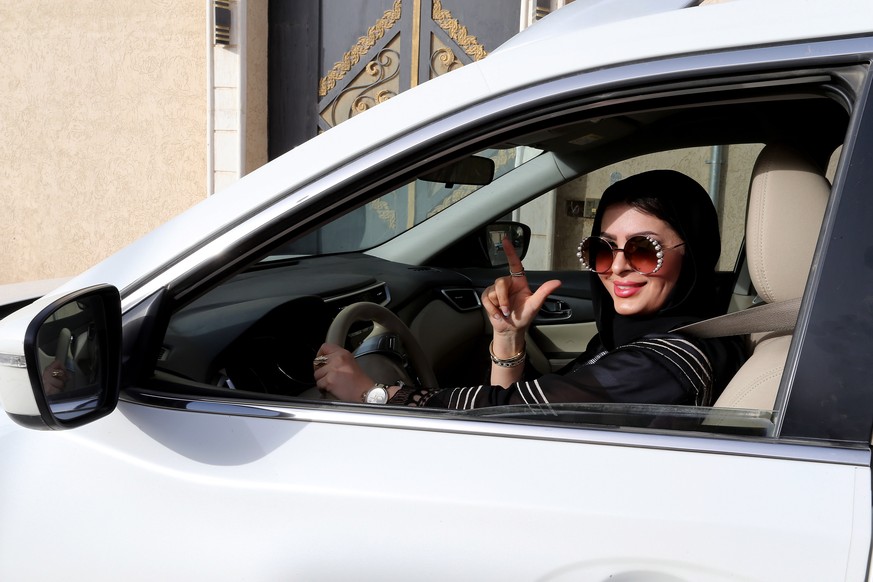 epa06836502 Huda al-Badri, 30, poses behind a steering wheel as women are alowed to drive for the first time through the streets of the capita, Riyadh, Saudi Arabia, in the early morning hours of 24 J ...