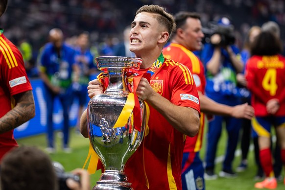 Spain vs England during the UEFA EURO, EM, Europameisterschaft,Fussball 2024 final match in Berlin, Germany Fermin Lopez of Spain celebrates with Henri Delaunay Trophy during the UEFA EURO 2024 final  ...