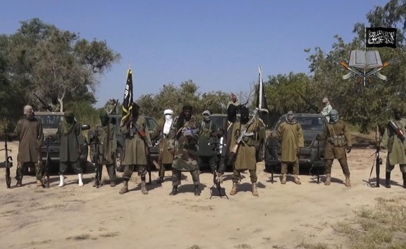 FILE - In this file image taken from video released Friday Oct. 31, 2014, by Boko Haram, Abubakar Shekau, centre, the leader of Nigeria&#039;s Islamic extremist group, surrounded by his fighters. Nige ...