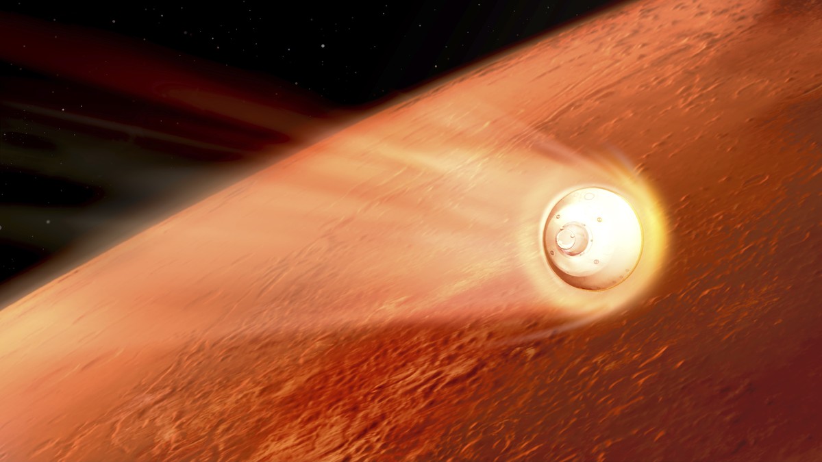 In this illustration made available by NASA, the spacecraft containing the Perseverance rover slows down using the drag generated by traveling through the Martian atmosphere. (NASA/JPL-Caltech via AP)
