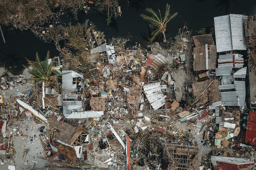 This photo provided by Greenpeace shows damaged homes due to Typhoon Rai in Surigao City, southern Philippines Tuesday Dec. 21, 2021. The governor of a central Philippine province devastated by Typhoo ...