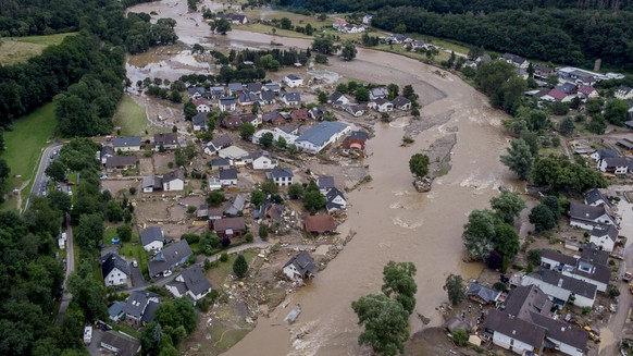 The Ahr river floats past destroyed houses in Insul, Germany, Thursday, July 15, 2021. Due to heavy rain falls the Ahr river dramatically went over the banks the evening before. (AP Photo/Michael Prob ...