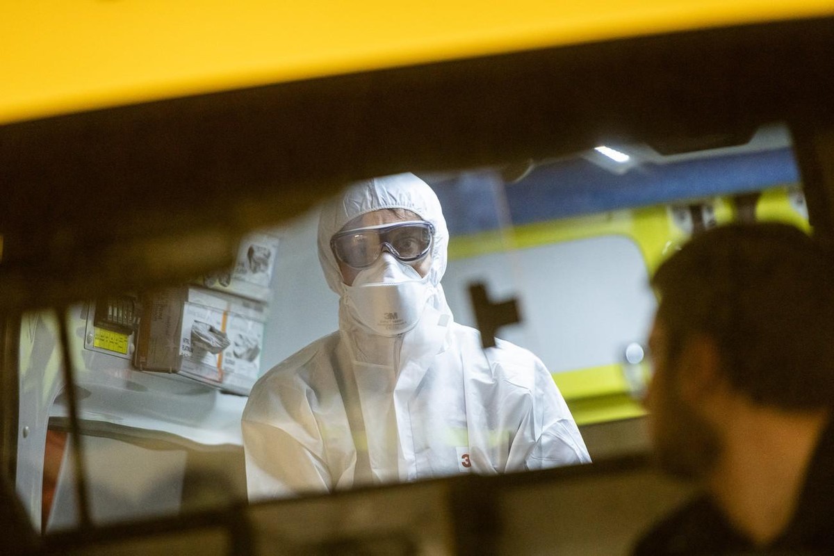 An ambulance health care worker of the Mendrisiotto Ambulance Service is puting on his mask and protection gear to practice for an Coronavirus emergency in Mendrision, Switzerland, Wednesday, February ...
