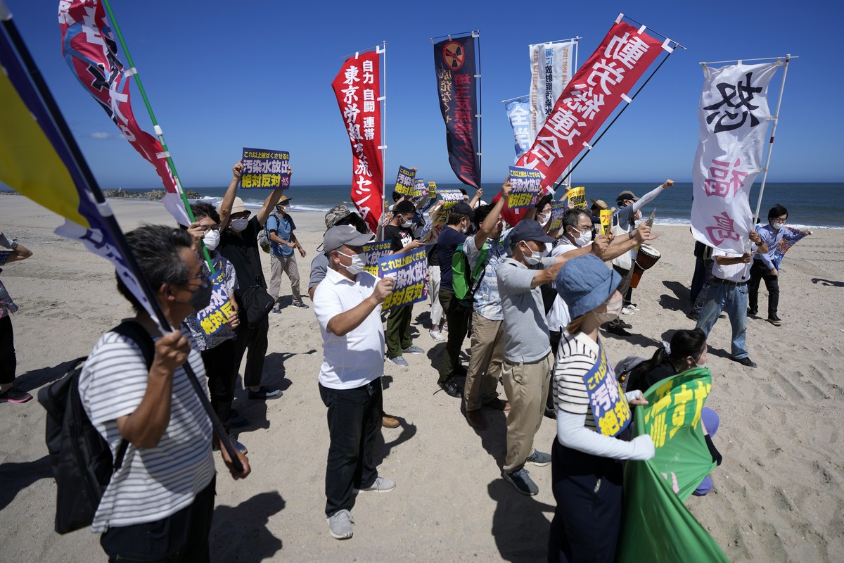 People protest at a beach toward the Fukushima Daiichi nuclear power plant, damaged by a massive March 11, 2011, earthquake and tsunami, in Namie town, northeastern Japan, Thursday, Aug. 24, 2023. The ...