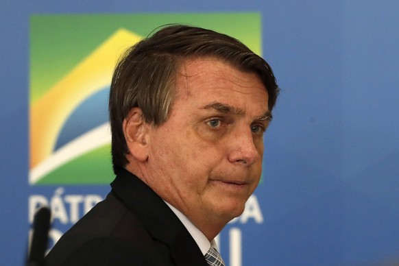 Brazilian President Jair Bolsonaro leaves a ceremony where he signed a law that expands the federal government&#039;s ability to acquire COVID-19 vaccines, at Planalto presidential palace in Brasilia, ...