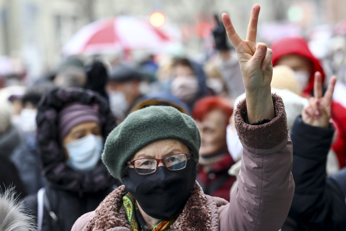 A woman wearing a face mask to protect against coronavirus gestures as she attends a pensioners' opposition rally to protest the official presidential election results in Minsk, Belarus, Monday,  ...