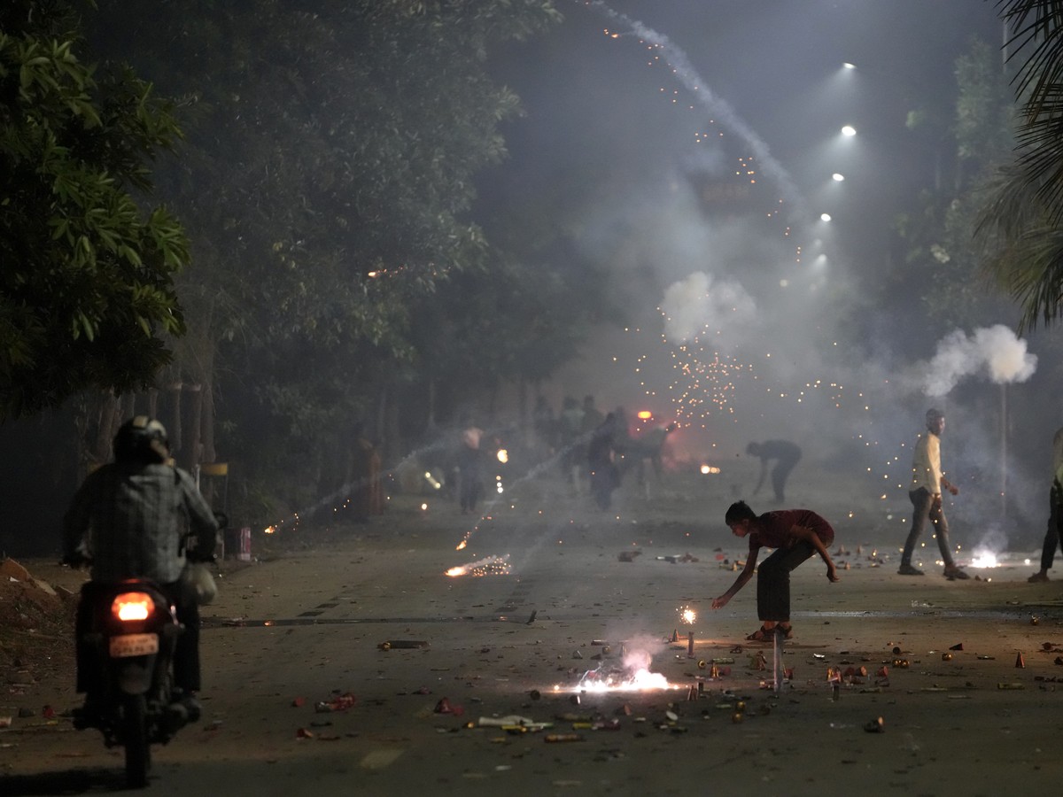 People lights firecrackers to celebrate Diwali, the festival of lights, in Ahmedabad, India, Monday, Oct. 24, 2022. (AP Photo/Ajit Solanki)