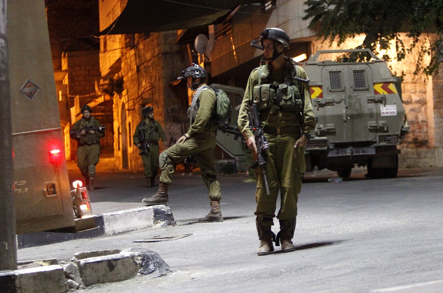 epa04290958 Israeli soldiers patrol in the West Bank city of Hebron, early 30 June 2014. Israel continues searching the Hebron area for the three missing Israeli teenagers that are presumed to have be ...