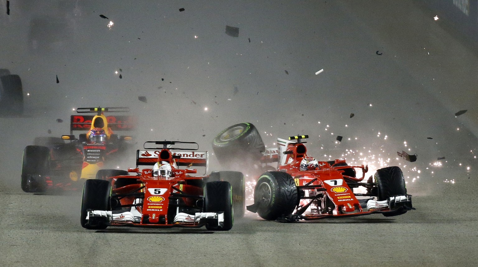 FILE - This is a Sunday, Sept. 17, 2017 file photo of Ferrari driver Kimi Raikkonen, right, of Finland colliding with teammate Sebastian Vettel of Germany at the start of the Singapore Formula One Gra ...